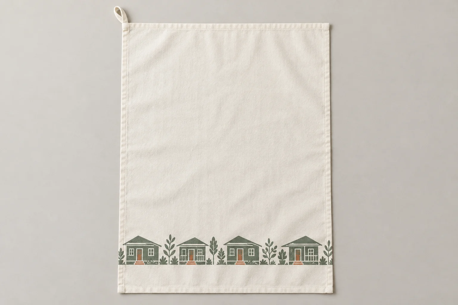 Cream cotton kitchen towel with a lower border of sage houses and terracotta details
