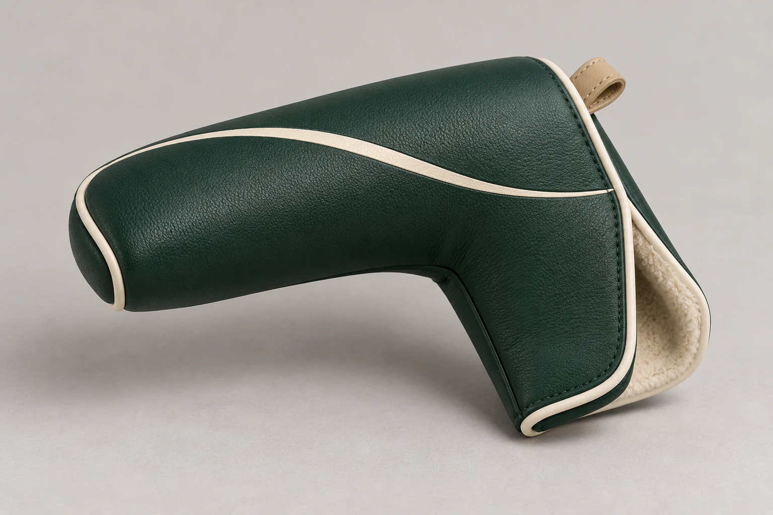 Forest-green blade putter cover with cream piping, curved fairway detail and a partly open lined heel flap