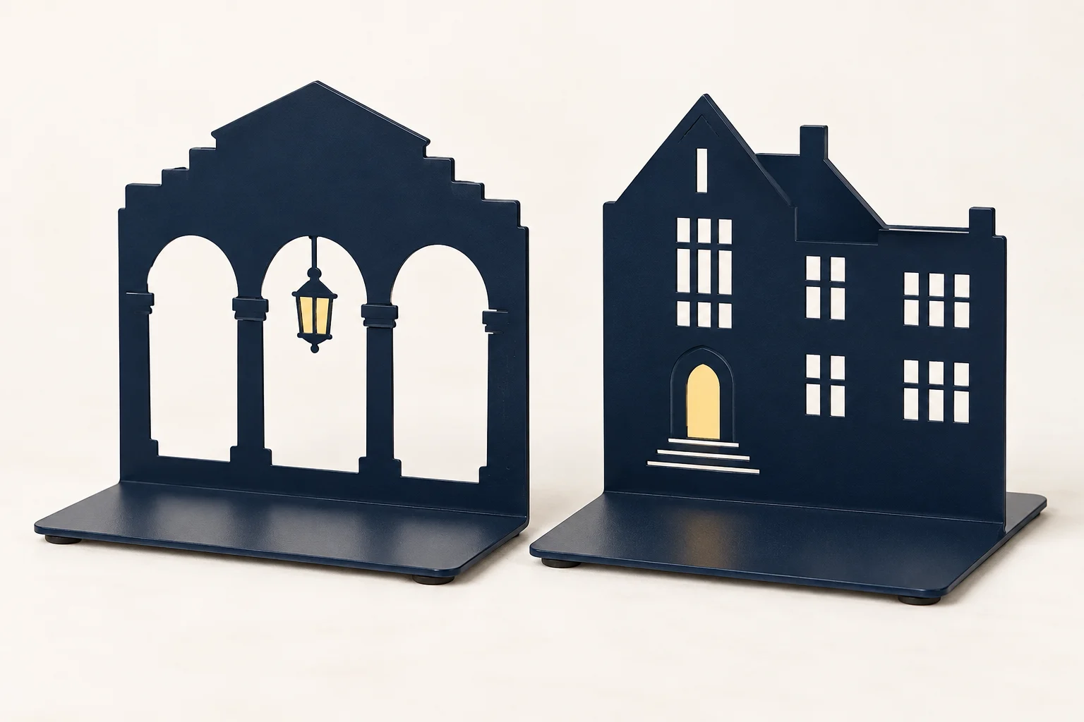 Pair of midnight-blue steel bookends with campus building silhouettes and arch cutouts