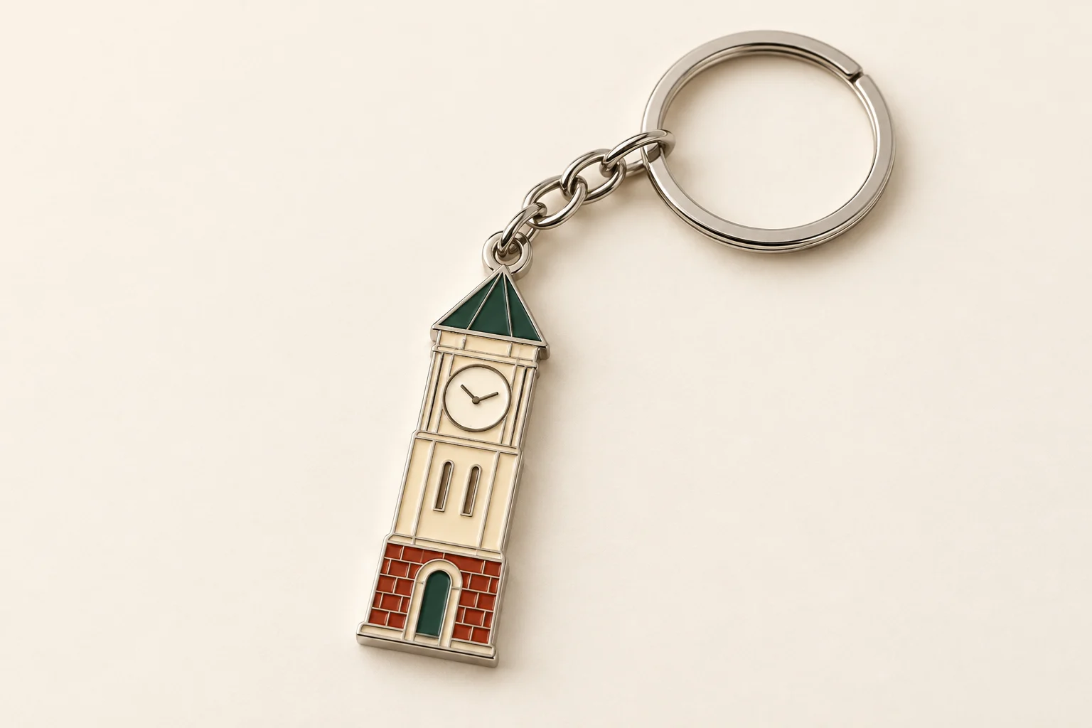 Thin clock-tower keychain with pine-green and cream fill and silver ring